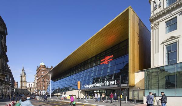 Glasgow Queen Street railway station, with modern fully glazed facade framed by a wooden awning